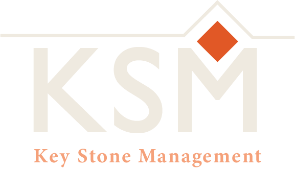 Key Stone Management transparent logo with a lightly-tinted capital KSM and an orange diamond above the M, representing their management of homeowner associations.